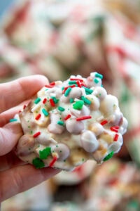 hand holding a white chocolate peanut cluster